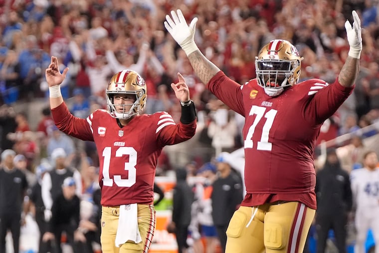San Francisco 49ers quarterback Brock Purdy (13) and offensive tackle Trent Williams celebrate after a touchdown run by Elijah Mitchell during the second half against the Detroit Lions.