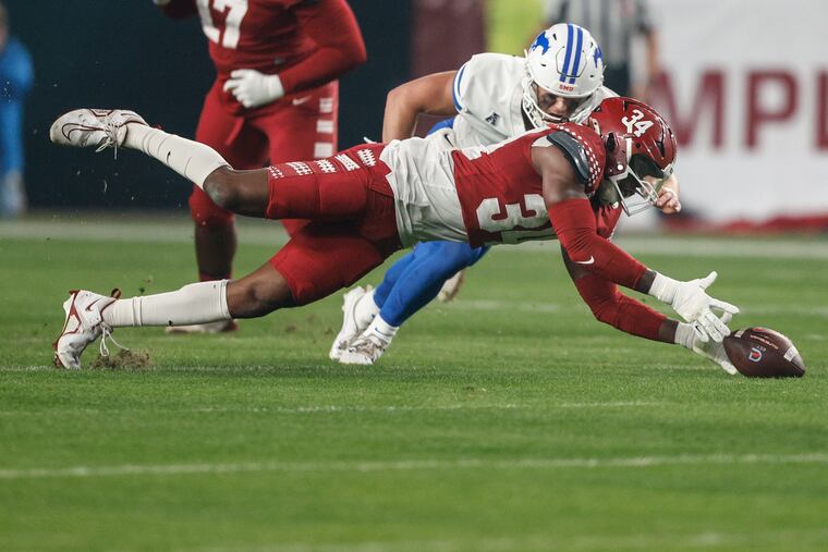Temple Diwun Black jumps on a fumble during the Owls' game against SMU. It was one of a handful of highlights on an otherwise dismal night for the Owls.