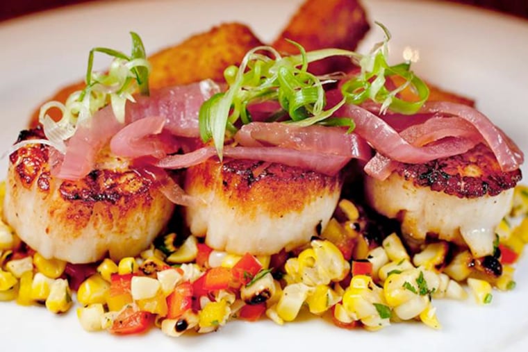 Local Viking Village scallops with potato-chorizo croquettes, charred corn salsa, and aji-amarillo sauce, served at the Arlington in Ship Bottom.