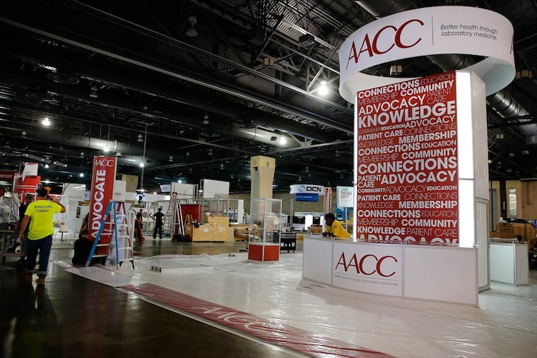Workers set up at the Convention Center for the American Association of Clinical Chemistry’s annual meeting. It will start Sunday and continue for five days.