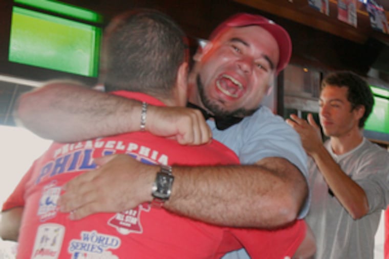 Phillies fans share the joy at Chickie & Pete's in South Philadelphia after the team clinched the National League East.