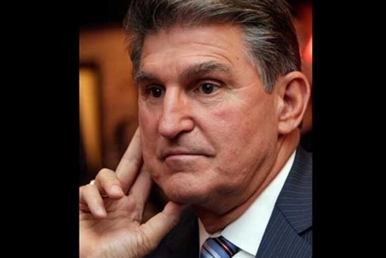 FILE - In this Nov. 6, 2012 file photo, Sen. Joe Manchin, D-WV., watches vote returns at his election watch party in Fairmont, W.Va. Sen. Joe Manchin, a lifelong member of the National Rifle Association, said Monday, Dec. 17, 2012, that it was time to discuss gun policy and move toward action on gun regulation. (AP Photo/Dave Martin)