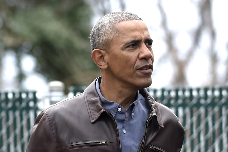 Former president Barack Obama watches as children play on the "Malia and Sasha's Castle," the playground that the Obamas donated to the Jobs Have Priority Naylor Road Family Shelter, just days before leaving office.