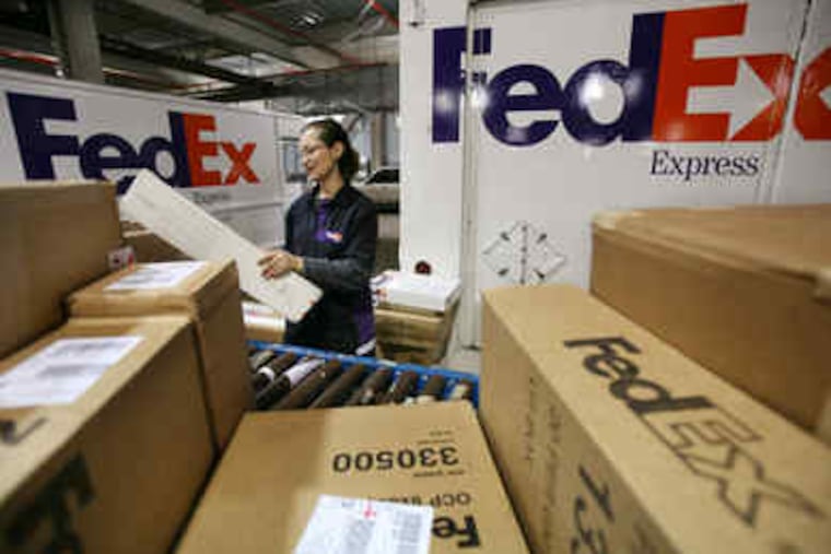 Rosa Santiago sorts packages before loading them onto delivery trucks at the FedEx Express Station in New York. At package-delivery behemoths FedEx and UPS, Wall Street's meltdown meant a sharp drop-off in the number of documents and packages sent overnight.