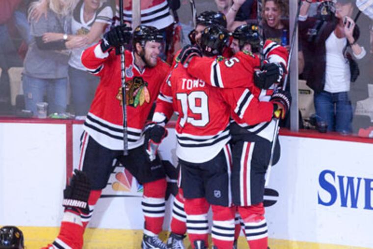 The Blackhawks celebrate after scoring a goal in game two of the Stanley Cup Final.(Ed Hille / Staff Photographer)