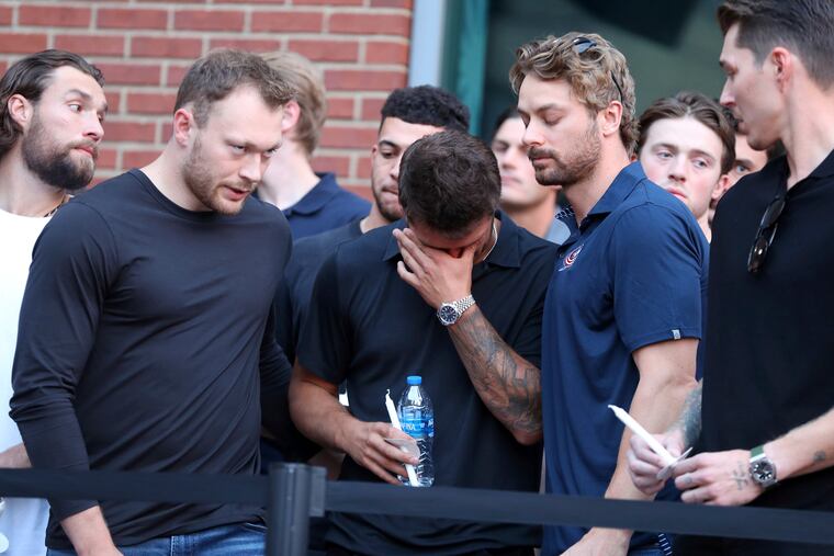 Columbus Blue Jackets players mourn the death of former teammate Johnny Gaudreau at Wednesday's vigil.