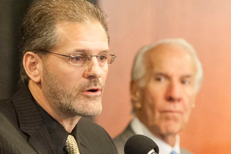 Flyers GM Ron Hextall (left) and chairman Ed Snider talk after hiring coach Dave Hakstol.