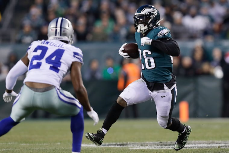 Eagles running back Miles Sanders runs with the football against Dallas Cowboys cornerback Chidobe Awuzie on Sunday, December 22, 2019 in Philadelphia.