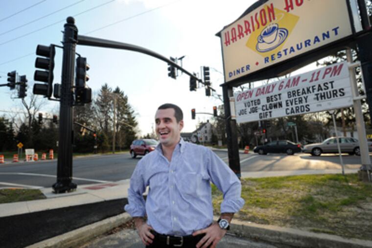 Constantine Benas, whose family runs the Harrison House, waits at the
corner in Mullica Hill where the new Route 322 Bypass begins.