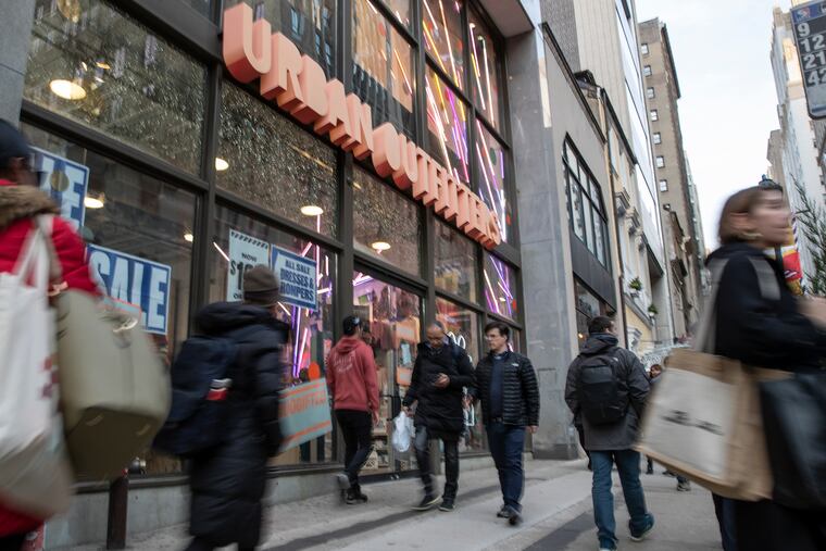 People walk outside the Urban Outfitters store by 16th and Walnut street in Center City Philadelphia on Nov. 15, 2019.