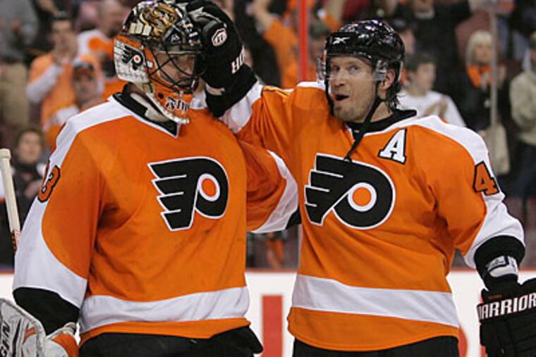 Brian Boucher and Kimmo Timonen celebrate after the Flyers' Game 4 win over the Devils. (Yong Kim/Staff Photographer)