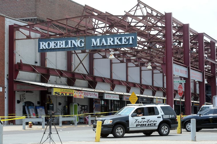 Police guard the perimeter Monday, June 18, 2018, of the scene where a shooting occurred early Sunday, June 17, 2018, that left 22 people shot or injured and a suspected gunman dead at the Art All Night festival in Trenton, New Jersey.