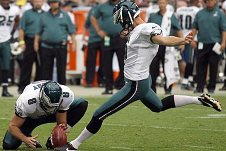 Alex Henery kicks at Arizona with since-released punter Chas Henry holding. (Yong Kim/Staff Photographer)