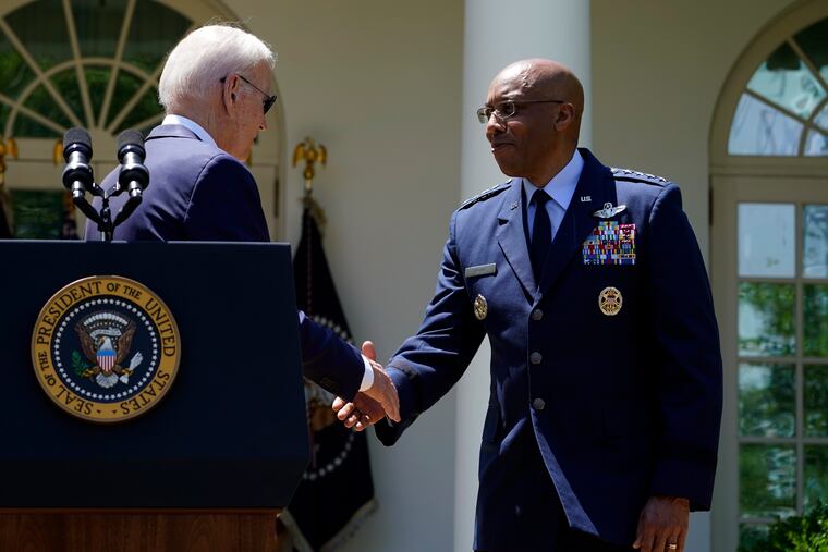 President Joe Biden shakes hands with U.S. Air Force Chief of Staff Gen. Charles Q. Brown Jr. after nominating Brown as the next chairman of the Joint Chiefs of Staff on Thursday.