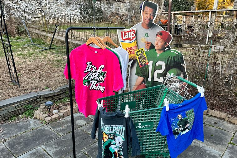 A small section of Dan McQuade's bootleg t-shirt collection, including other Eagles novelty items he has sourced for the exhibit.