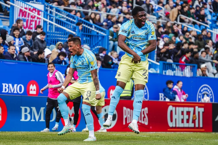 Jesús Bueno (left) and Ezekiel Alladoh celebrate after Alladoh set up Bueno to score the winning goal for the Union on Saturday in Montréal.