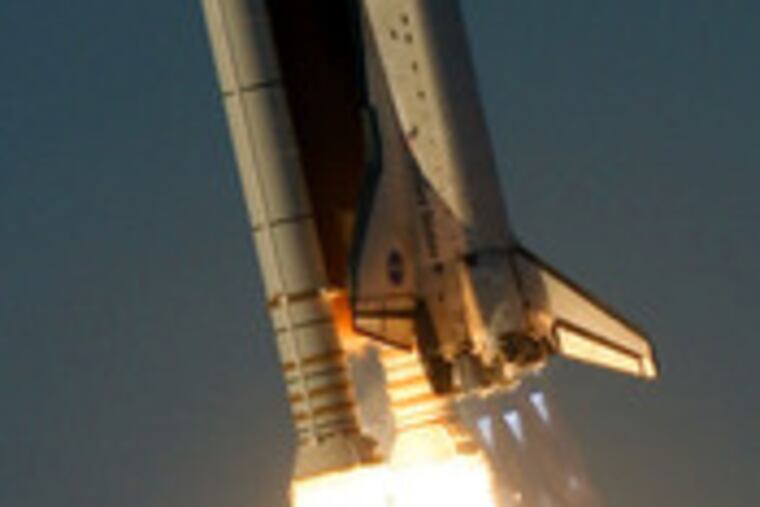 Atlantis lifts off after a three- month delay caused by damage from a freak storm.