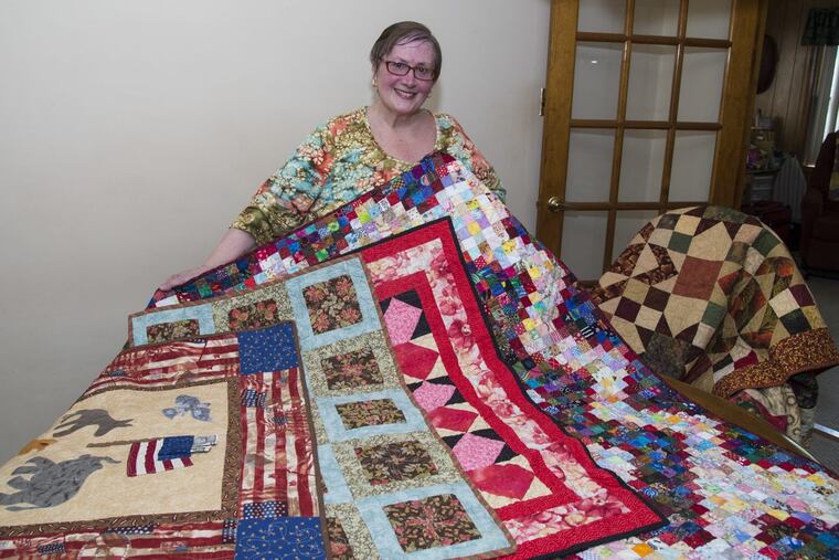 Quilt maker Donna Laing, 67, displays some of her favorites in her Warminster home workshop. She will be among 80 artisans exhibiting 121 quilts at the 13th Annual Bucks County Quilt Show in Bensalem throughout July and August. CLEM MURRAY/ Staff Photographer