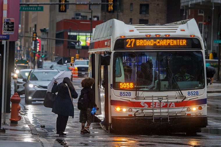 Commuters wait to board the 27 SEPTA bus on a rainy Friday morning at 15th and Market Streets. Transit facilitates investment, boosts property values, and ensures broader access to opportunity, writes the Editorial Board.