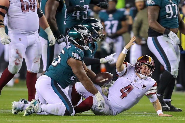 Commanders quarterback Taylor Heinicke reacts after a late hit was called on Eagles linebacker Haason Reddick and defensive end Brandon Graham late in the game.