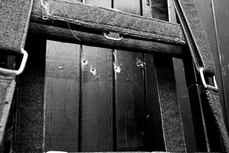 Four bullet holes are visible on the wood panel behind the chair where Ronnie Lee Gardner, 49, was seated when he faced a firing squad of five police officers early Friday morning.