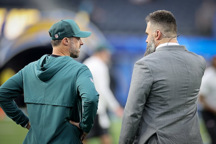 Former Eagles offensive coordinator Kevin Patullo (left) chats with former center Jason Kelce before a "Monday Night Football" game against the Chargers.