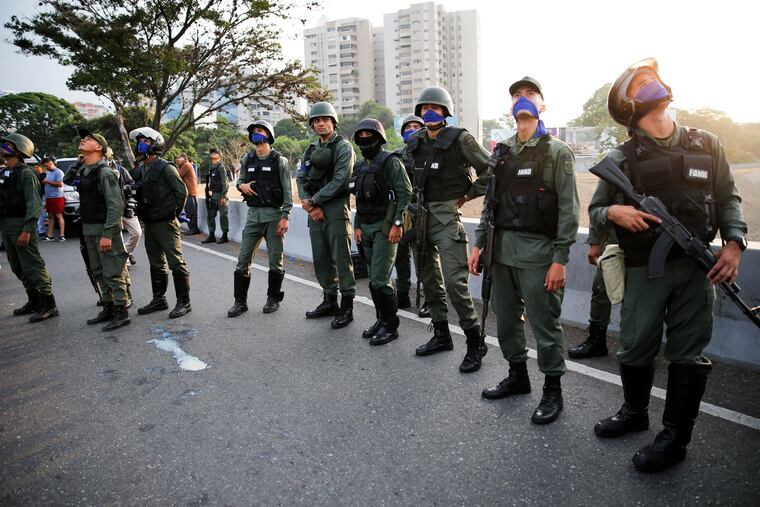 Uprising soldiers stands outside La Carlota air base in Caracas, Venezuela, Tuesday, April 30, 2019. Venezuelan opposition leader Juan Guaido appeared in a video with a small contingent of armed soldiers and formerly detained opposition activist Leopoldo Lopez calling for Venezuelans to take to the streets to oust President Nicolas Maduro.