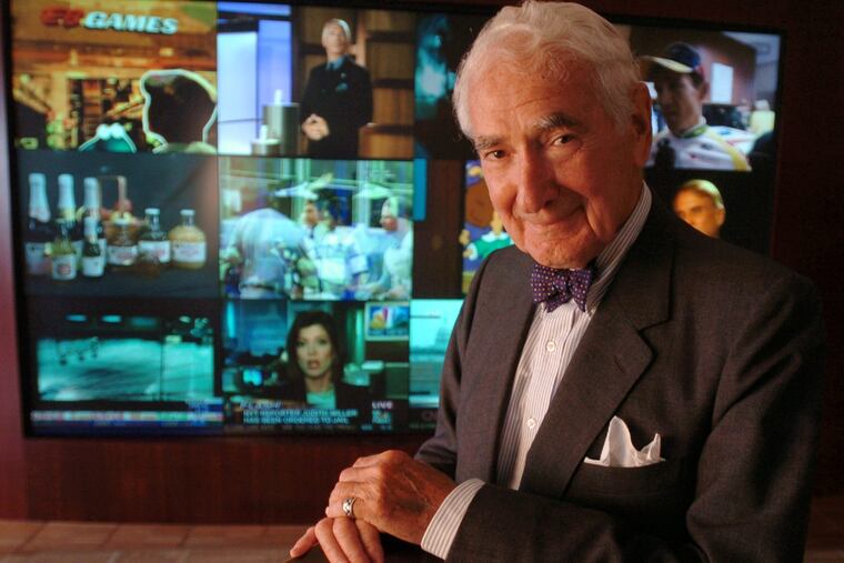 Ralph Roberts poses in front of a wall of 12 television monitors in the lobby of Comcast executive offices on the 35th floor of 1500 Market Street.