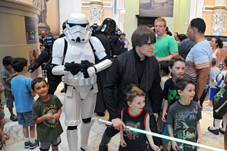 An Empire stormtrooper and Luke Skywalker, aka Ryan Miorelli, strike poses with some young fans at the Please Touch Museum on July 22, 2013. (CLEM MURRAY/Staff Photographer)