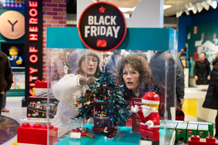 Black Friday shoppers admire a Christmas LEGO set at the LEGO flagship store in New York on Friday, Nov. 28, 2025.