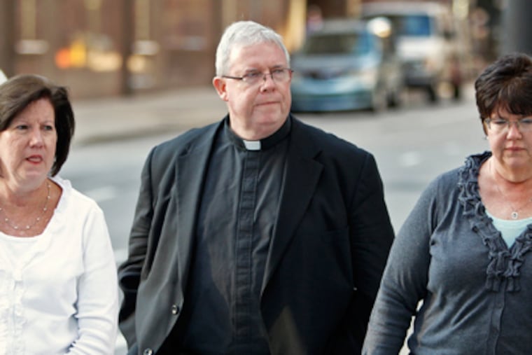 Oct. 2011 file photo: Monsignor William Lynn enters the courthouse with two unidentified women.( Alejandro A. Alvarez / Staff Photographer )