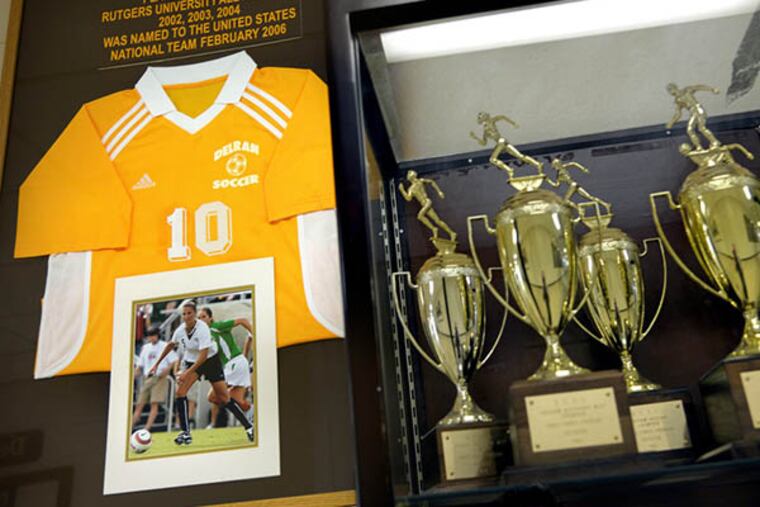 The jersey of hometown hero Carli Lloyd (DHS Class of 2001) at the Delran High School trophy case July 6, 2015, the day after she scored a hat trick in the World Cup final. ( TOM GRALISH / Staff Photographer )
