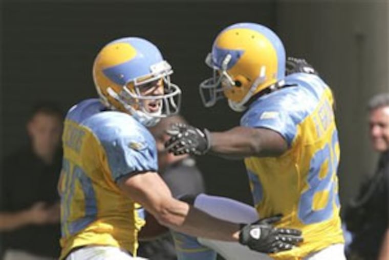 Kevin Curtis, left, and Reggie Brown celebrate Curtis's 68-yard touchdown on a pass from Donovan McNabb in the first half. Curtis also had TD catches of 43 and 12 yards before intermission.