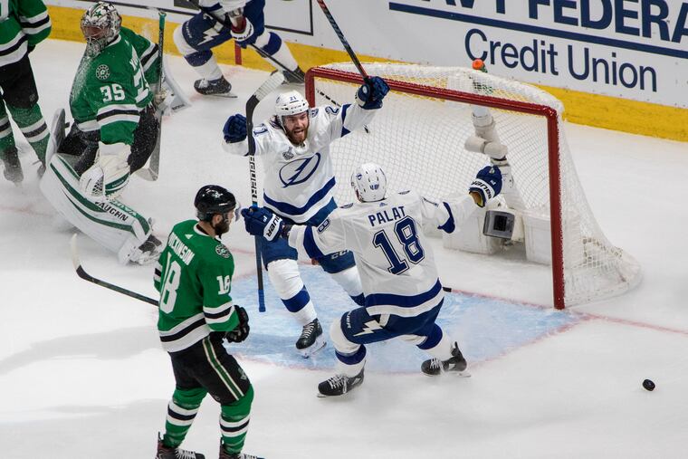 Tampa Bay Lightning center Brayden Point (21) celebrated his goal with teammate Ondrej Palat, right, as Dallas Stars goaltender Anton Khudobin (35) and center Jason Dickinson, front left, reacted during Game 3 of the Stanley Cup Final on Wednesday night.