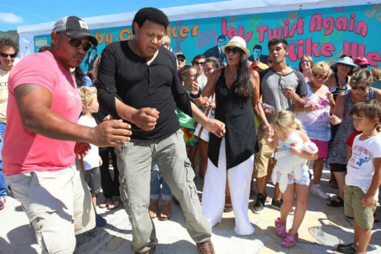 Chubby Checker dancing to "The Twist" on Monday in front of a newly unveiled Wildwood mural of the singer. Checker first performed the hit song live in Wildwood in 1960. (TOM BRIGLIA / For The Inquirer)