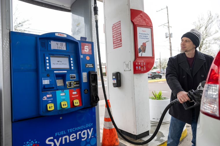 Mike Dettra, 43, of Newtown, Bucks County, fill his tank at an Exxon station Thursday. “It stinks,” Dettra said. “It makes it hard to do your daily activities.”