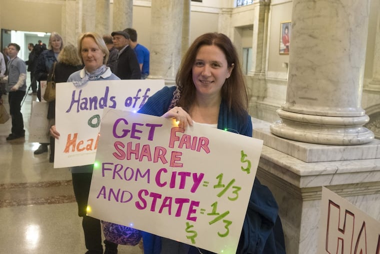 Faculty protest lack of a contract last year at Community College of Philadelphia’s board of trustees meeting.