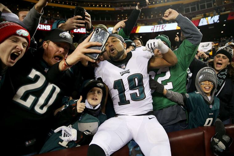Golden Tate celebrates with fans in the stands after the Eagles' win on Sunday.