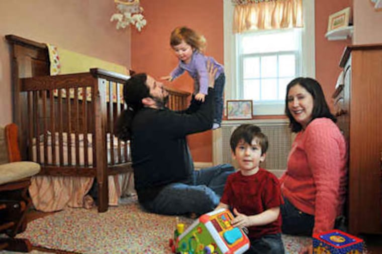 Steve and Amy Jo Bader of Bala Cynwyd play with daughter Lucy, 18 months, and son Sam, 3. Bader is expecting and hopes for a sister for Lucy, though not in "an all-or-nothing kind of way," she says. (Sharon Gekoski-Kimmel / Staff Photographer)