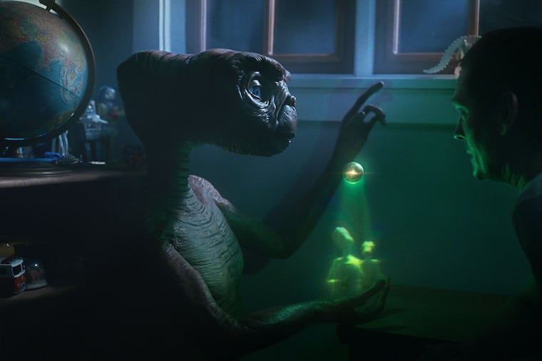 A still image from Comcast's new commercial featuring E.T. and Henry Thomas, the actor who played Elliott in the 1982 blockbuster.