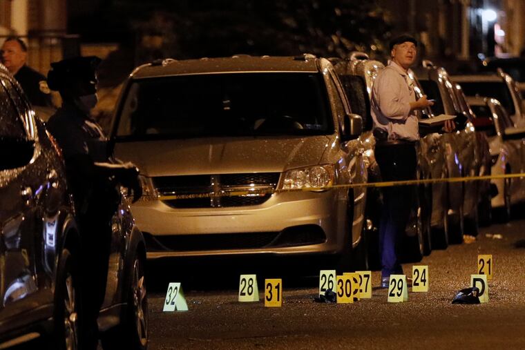 Philadelphia Police process evidence at South Cleveland and Moore Streets in South Philadelphia after four teens were shot, two fatally, just after 8 p.m. Wednesday.