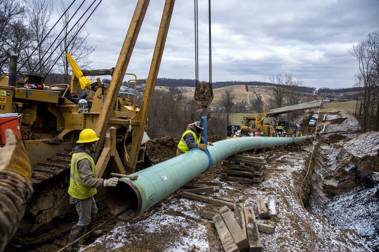 Workers install 20-inch epoxy-coated pipes on the Mariner East 2 pipeline in Washington County
