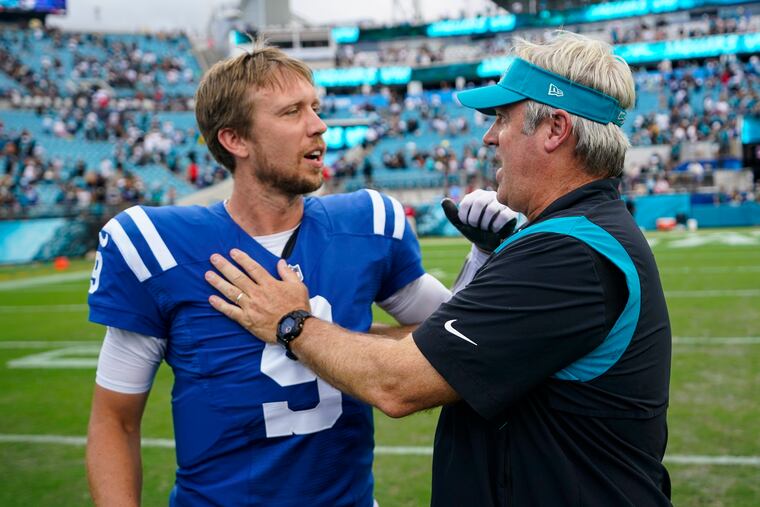 Jacksonville Jaguars head coach Doug Pederson meeting with Indianapolis Colts quarterback Nick Foles after their game on Sept. 18.
