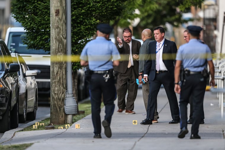 Police on the scene in the 3500 block of Fairmount Avenue where 4 people were shot Wednesday. One of the men was in critical condition, police said.