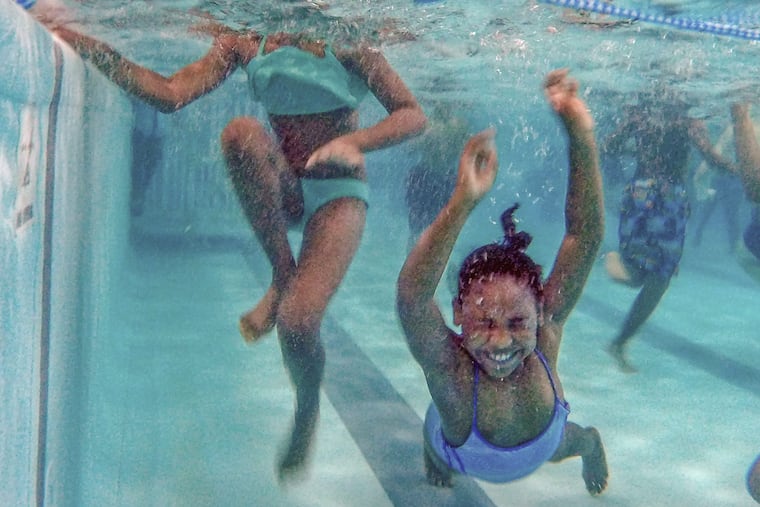 Heaven Gonzalez, 8, closes her eyes and goes under the water during her swim time at the Germantown Life Enrichment Center.
