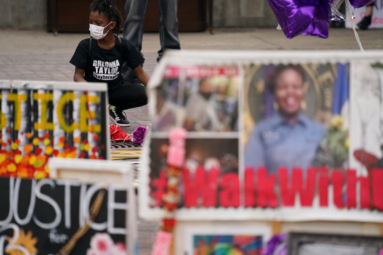 People gathered in Jefferson Square awaiting word on charges against police officers Wednesday in Louisville, Ky. A grand jury indicted one officer on criminal charges six months after Breonna Taylor was fatally shot by police.