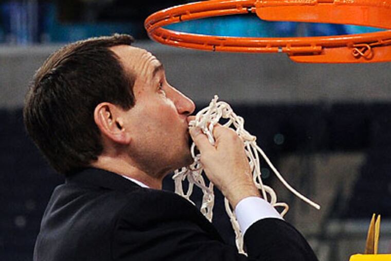 Duke coach Mike Krzyzewski kisses the net after the Blue Devils' 61-59 win over Butler. (Mark J. Terrill/AP)