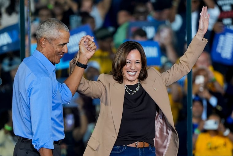 Former President Barack Obama holds hands with Democratic presidential nominee Vice President Kamala Harris after introducing her at a Georgia rally last week.