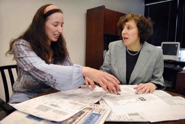Graphics editor Julia Elkin (left) goes over page layouts with Lisa Hostein, executive editor of the Jewish Exponent. "Everybody should feel engaged in the Jewish community, and a newspaper is a great way to make that happen," Hostein said.