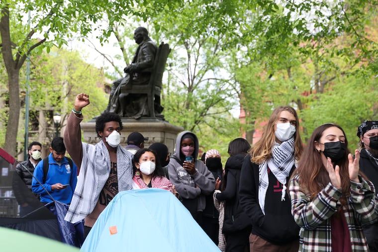 Pro-Palestine protesters chant at the encampment on Saturday.
